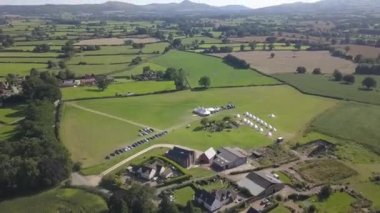 Aerial view. Wedding reception ceremony setup with big white tents and people enjoying. USA