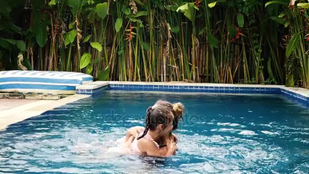 Mãe feliz e sua filha se divertir na piscina — Vídeo de Stock