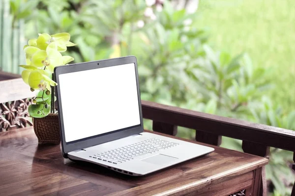 Laptop on wooden table nature