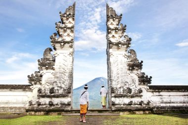 Indonesia - Bali - tourist standing betwen Lempuyang gate clipart