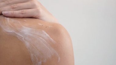 Omuz ve kadın ağır çekim yakın çekim yaymak vücut losyonu geri