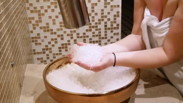 Ice spa bath shock therapy. Female washes face with ice after using sauna bath. — Stock Video