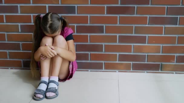 Child abuse. Little girl crying, sitting on the floor — 图库视频影像