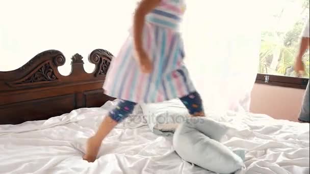 Little girl jumping on the bed at home — Stock Video