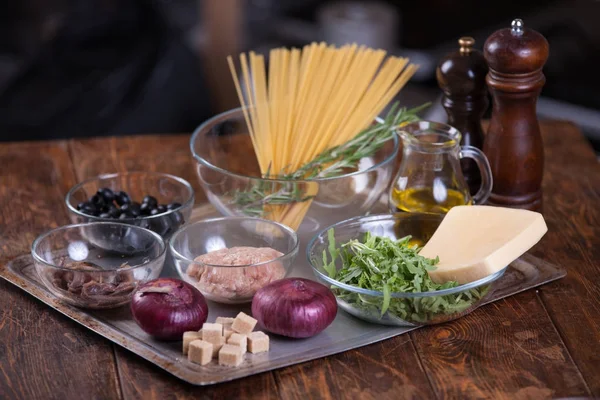 Pasta with anchovies and black olives — Stock Photo, Image
