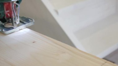 Adam fretsaw ve ahşap tahta ile çalışıyor. Erkek el Yapboz, yönetim kurulu iki parçaya kesim tarafından işletilen.