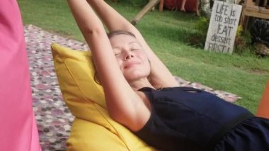 bir takas ile yeşil çim üzerinde bir çanta sandalyede kadını rahatlatır