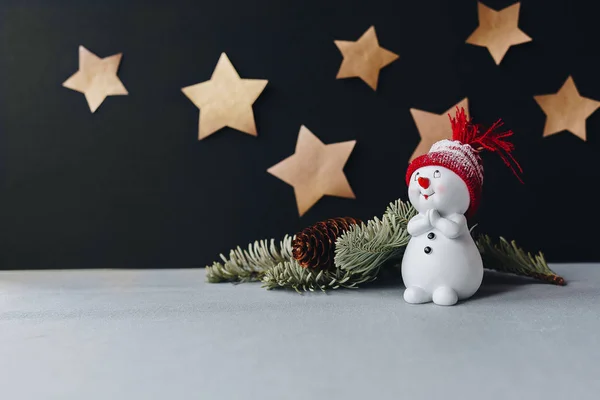 A lovely toy snowman in a red hat — Stock Photo, Image