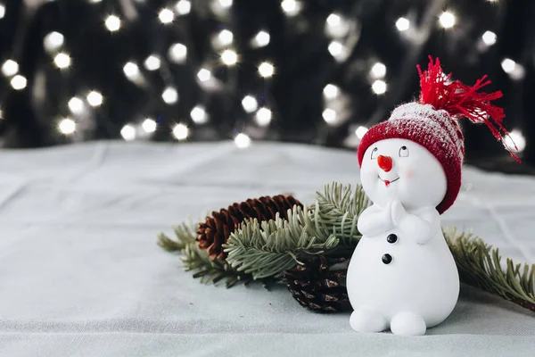A lovely toy snowman in a red hat — Stock Photo, Image