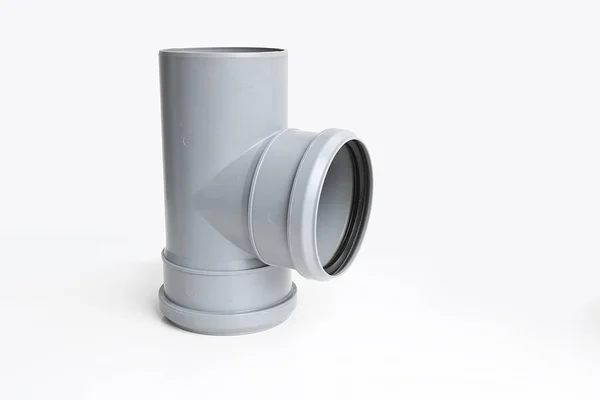 Plastic PVC pipes sewer fittings on a light background. — Stock Photo, Image