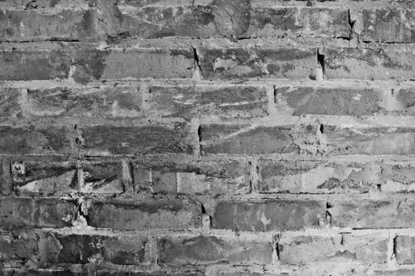 Old brick wall in cement mortar. Thresh brick masonry texture. Gloomy background. Close up.