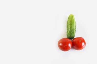 Kırmızı sulu domates ve yeşil salatalık. Doğal bileşenlerin erkeklik organı. Açık gri arkaplan