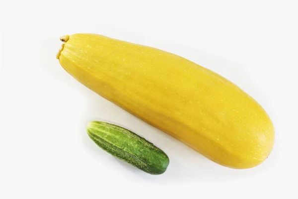 Bright yellow zucchini and green cucumber. Penis size concept in men, penis enlargement.
