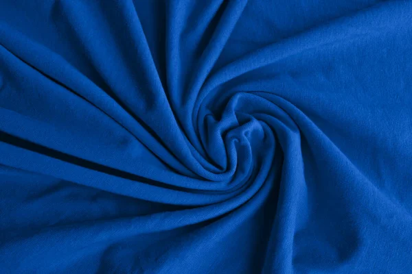 Classic blue delicate fabric draped and spun. Closeup.