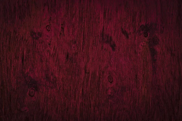 Dark burgundy wood texture. Texture of old dried plywood. Mahogany background for design.