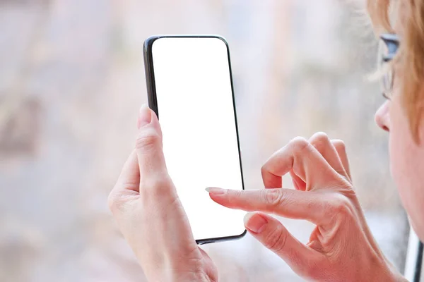 Female hand with smartphone, white blank screen with copy space.