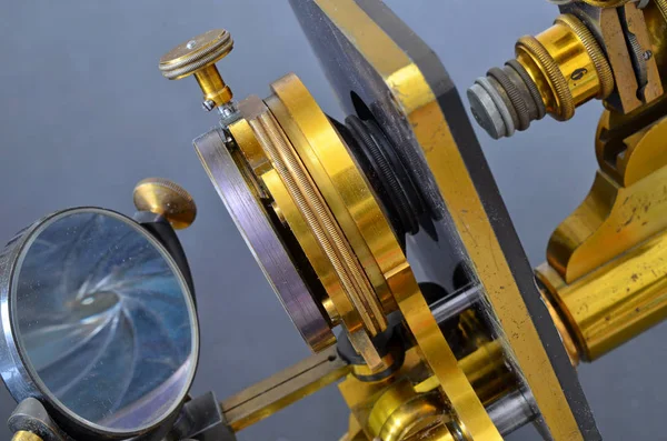 Vintage brass microscope on a dark background