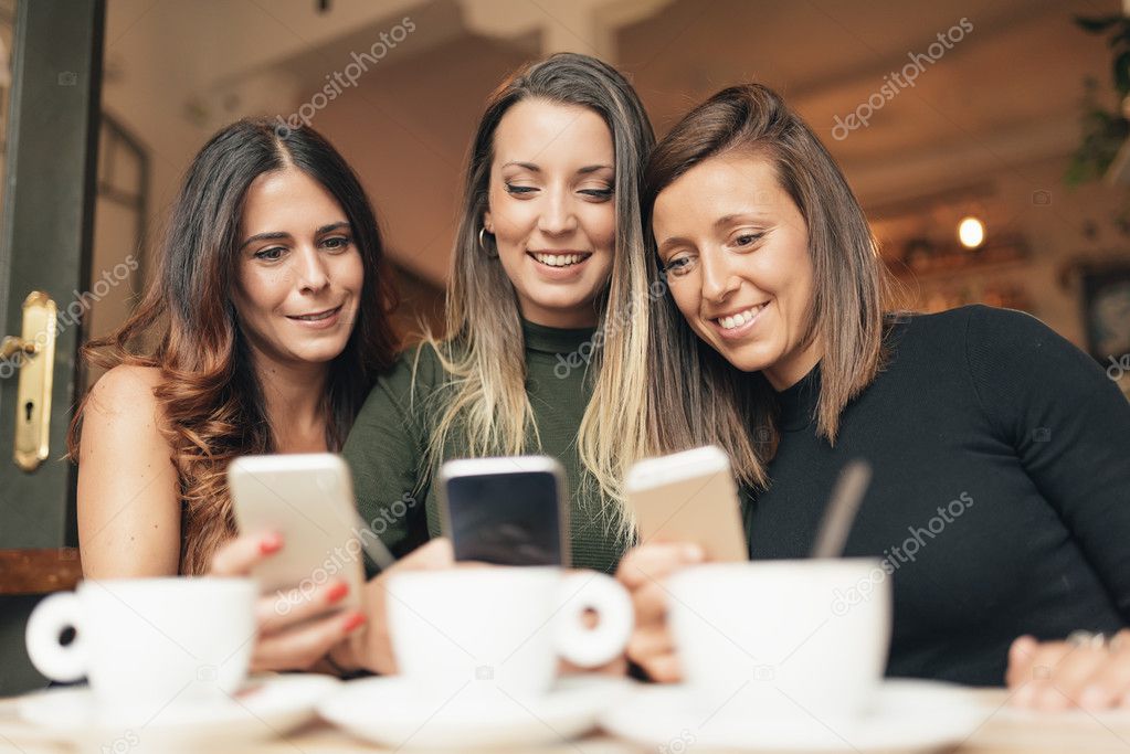 Friends watching social media in a smart phone.
