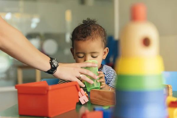 Happy baby drinking water and playing. — Stock Photo, Image