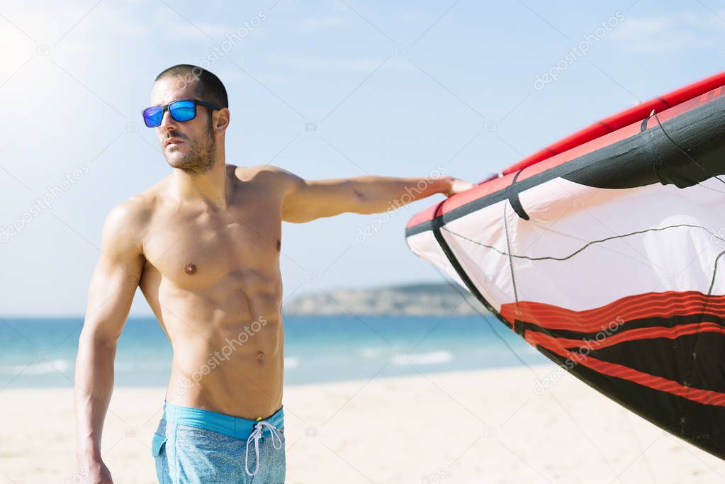 Portrait of handsome man kitesurfer.