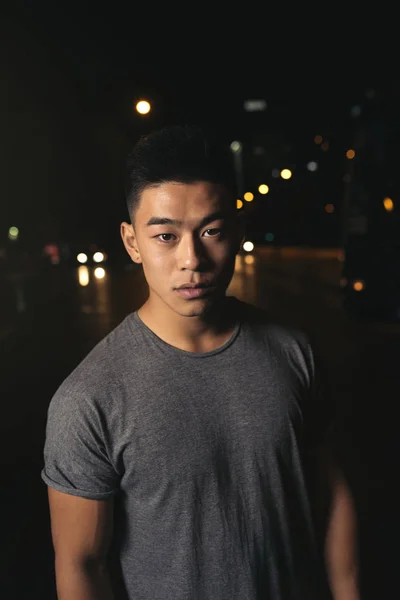 Portrait of a asian young man in the city.