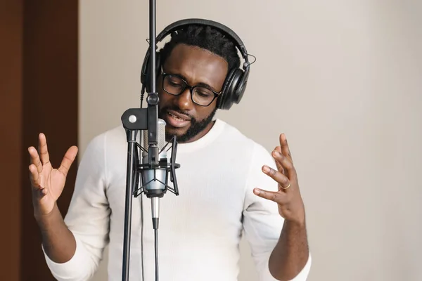 Afrikansk ung mann synger i musikkstudio . – stockfoto