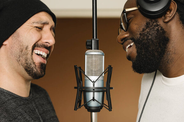 Multiracial artists singing on studio.
