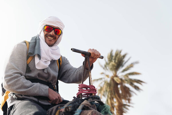 Young man ride on dromedary.