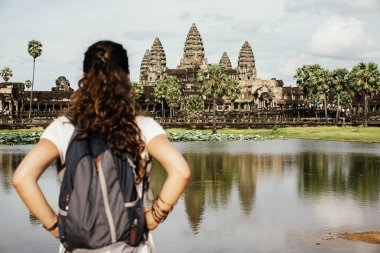 Woman looking Angkor Wat Temple. clipart