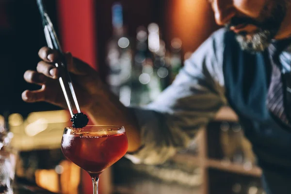 Barman is making cocktail at night club. Royalty Free Stock Images