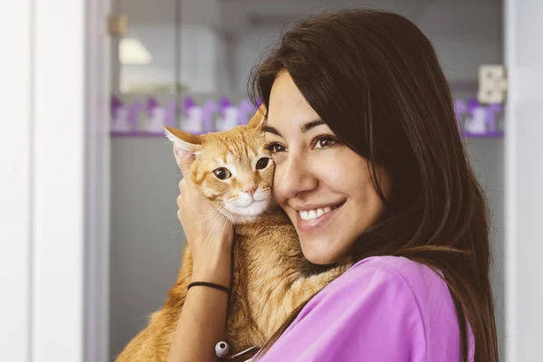 Veterinarian doctor hugging a little cat.