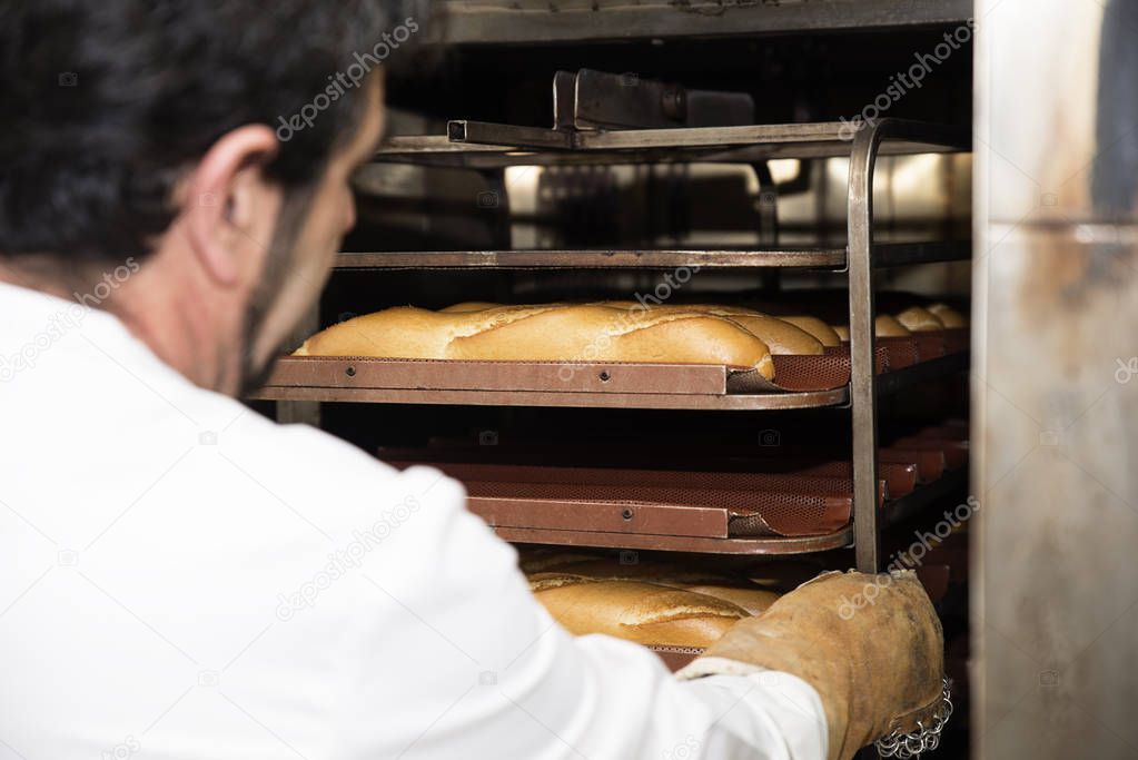 Baker making bread at a bakery.