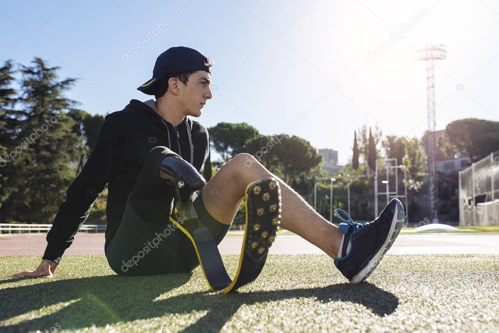 Portrait of disabled man athlete with leg prosthesis.