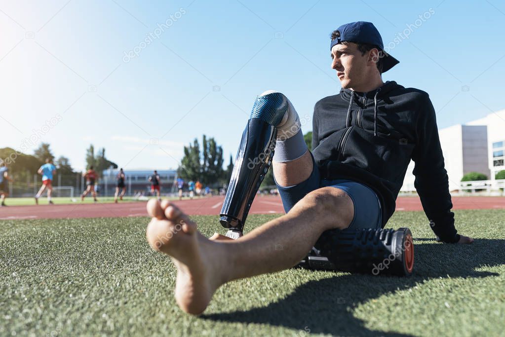 Portrait of disabled man athlete with leg prosthesis.