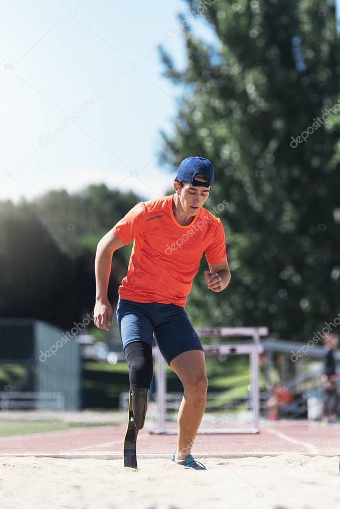 Disabled man athlete jumping with leg prosthesis. Paralympic Spo