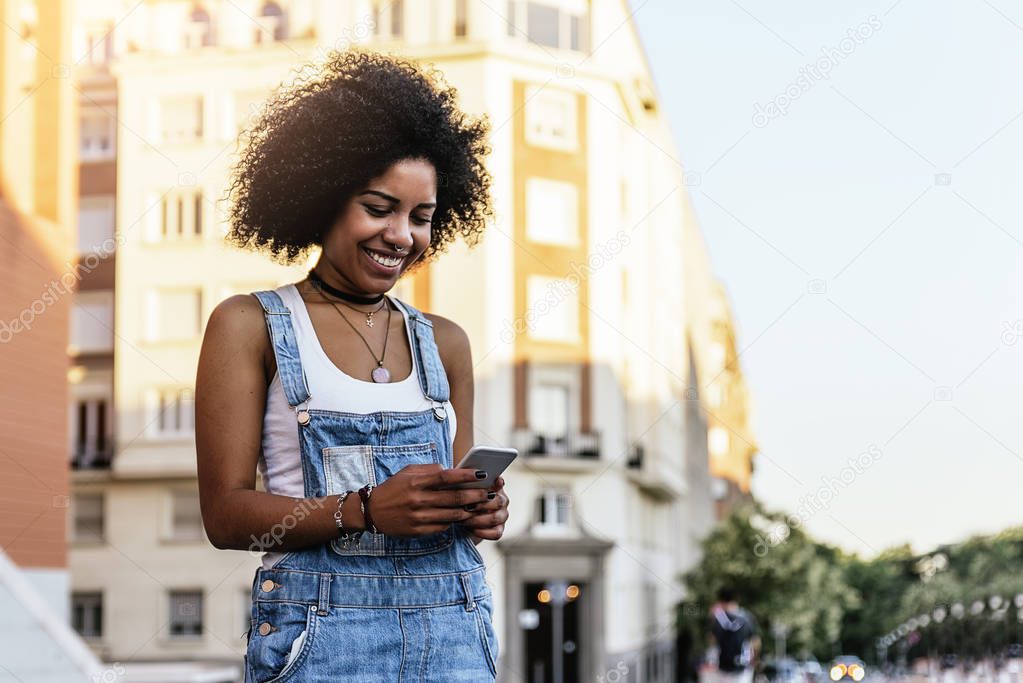 Beautiful woman using mobile in the Street.