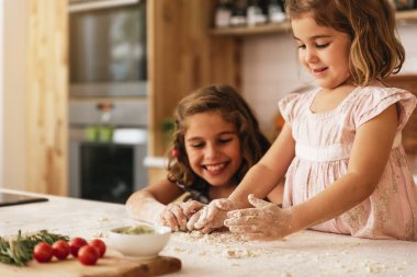 Little sisters Kurabiye Pişirme için hazırlanıyor hamur yoğurma.