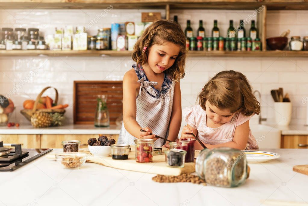 Little sisters girl preparing baking cookies.