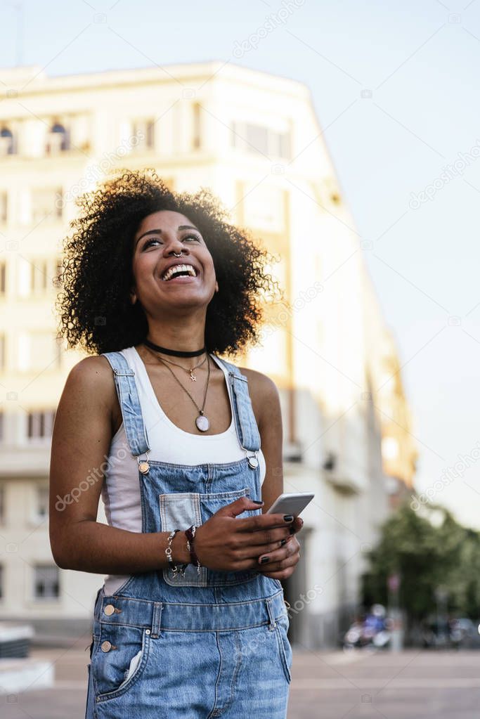 Beautiful woman using mobile in the Street.