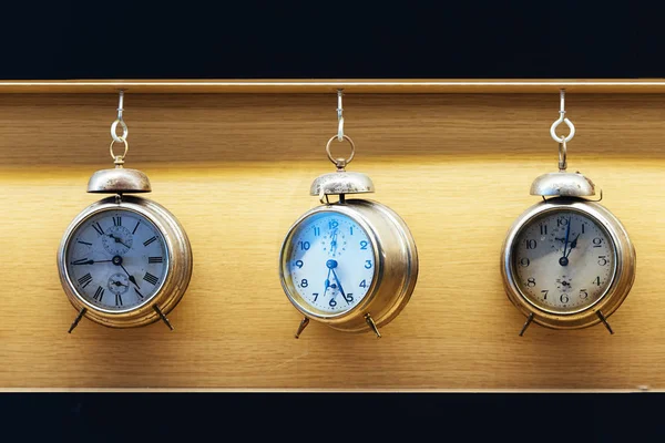 Vintage alarm clock on wood background.