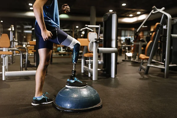 Disabled young man training in the gym