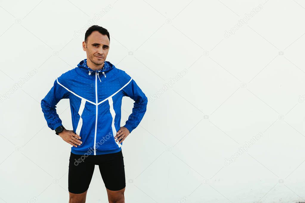 Portrait of handsome man runner in the city.