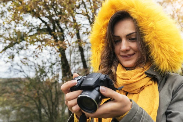 Young woman using a camera to take photo.