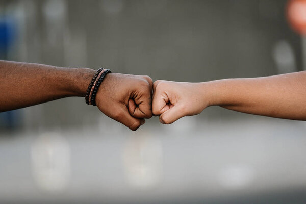 Close up of hands of different race.