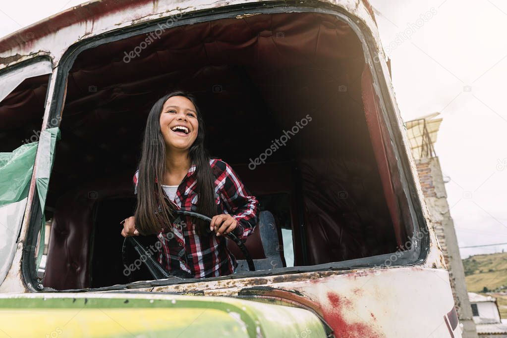 Cute girl playing in one abandoned truck. Poor infant concept.