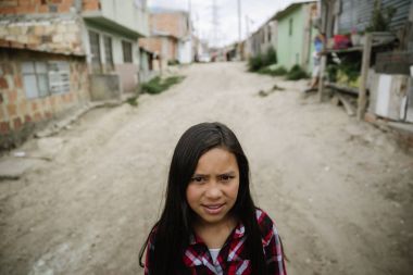 Portrait of cute girl in shanty town. clipart