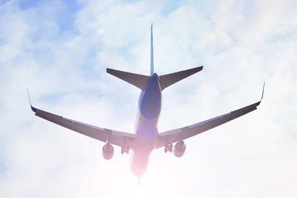 Plane flying through clouds in the sky. Jet aircraft. — Stock Photo, Image