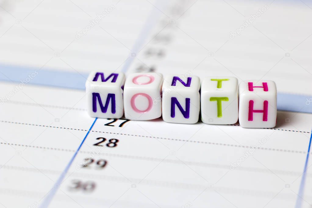Scoring of  cubes on a white background the word Month