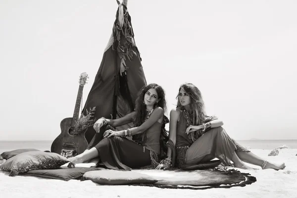 Two beautiful gypsy girls with guitar sitting on pillows at tepe ストックフォト