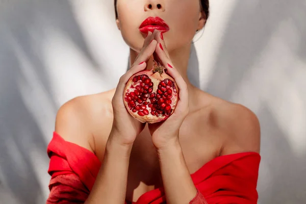 Piros ruhás gránátalma vonzó fiatal nő — Stock Fotó